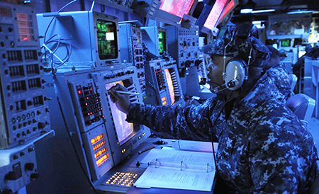 YOKOSUKA, Japan (Feb. 14, 2012) Operations Specialist 1st Class Lionel Mahoney, training supervisor aboard the Arleigh Burke-class guided-missile destroyer USS Stethem (DDG 63), records enemy locations during a fleet synthetic training scenario.